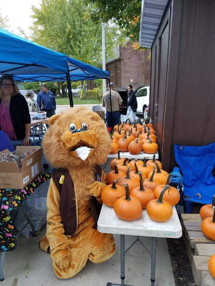 Lions mascot with pumpkins